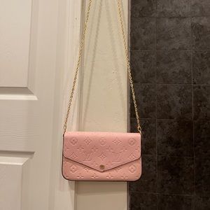 Pink crossbody. Like new. Has one small smudge on the Inside wallet insert.